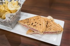 Grilled ham and cheese sandwich with chips